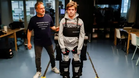 Father and son in robotic suit