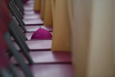 Clodagh Kilcoyne/ Reuters An Archbishop"s hat is seen on a chair during Mass at the Pastoral Congress at the World Meeting of Families in Dublin, Ireland