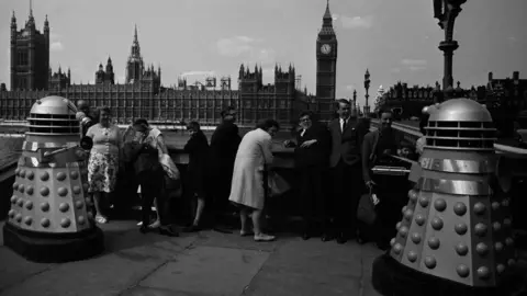 Getty Images Daleks with people opposite Houses of Parliament and Big Ben in August 1964.