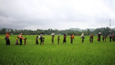 AFP Rohingya refugees from Rakhine state in Myanmar walk along a path near Teknaf in Bangladesh on September 3, 2017.