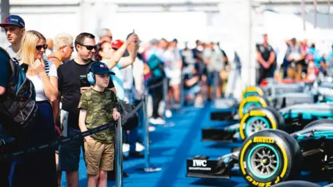 Silverstone Festival car enthusiasts looking at F1 racing cars