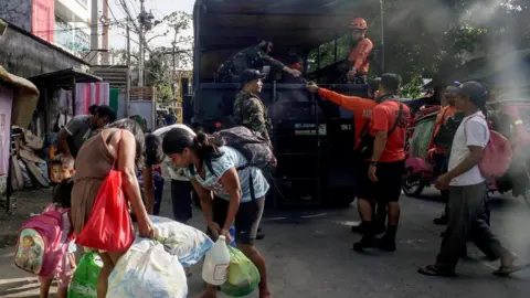 EPA Filipino villagers board a military truck during an evacuation following an eruption of the Mayon Volcano in the town of Camalig, Albay province, Philippines