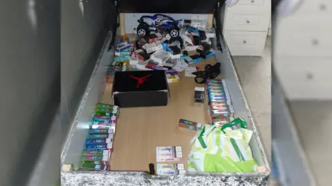 BBC Sport Approximately 50 illegal vape boxes hidden in storage under a bed