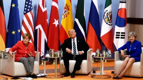 Reuters Angela Merkel, Donald Trump and Theresa May at the start of the summit