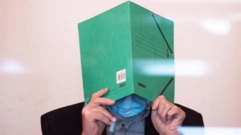 AFP Bruno Dey in court behind perspex screen, 20 May 20