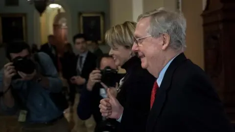 AFP Senate Majority Leader Senator Mitch McConnell (R-KY) walks to the floor of the Senate on Capitol Hill on 1 December 2017 in Washington, DC.