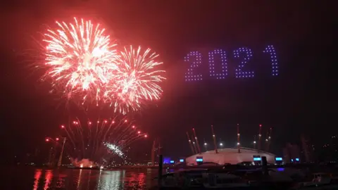 PA Media Fireworks and drones illuminate the night sky over the The O2 in London as they form a light display as London"s normal New Year"s Eve fireworks display was cancelled due to the coronavirus pandemic.