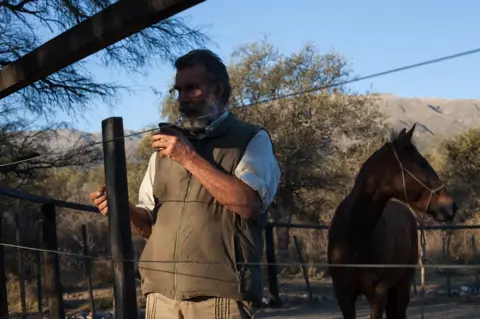 Erica Canepa Oscar in the farmyard with a wild horse