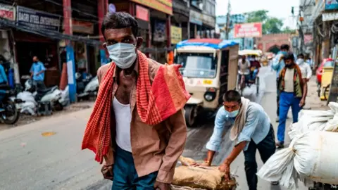 Getty Images Mask-wearing on the streets of India