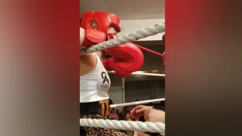 Emma Perkins Emma in the boxing ring with her gloves on