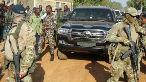 Reuters Wagner fighters on foot with a presidential convoy in CAR