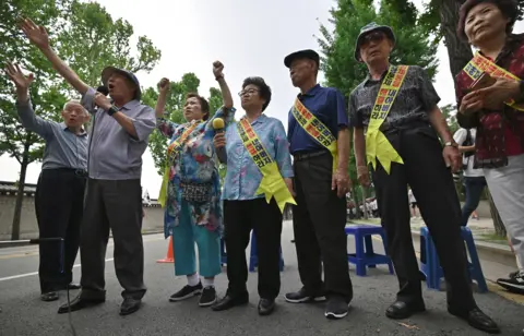 Getty Images Family members of South Korean victims of forced labour by Japan during World War Two, participate in a rally urging resolution of compensation in Seoul on 16 July