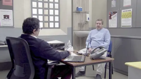 ITV Coronation Street character Johnny Connor talking to the prison doctor about his hallucinations