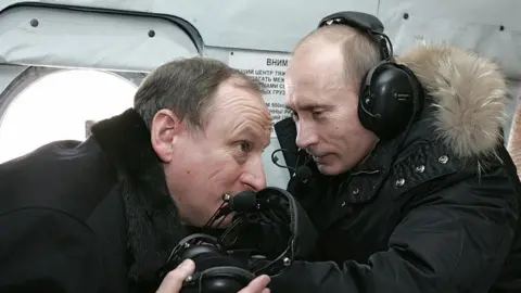AFP Mr Putin and Mr Patrushev on a helicopter to visit a military outpost