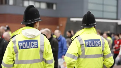 Getty Images Police with their backs to camera