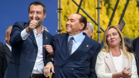 Getty Images Matteo Salvini of "Lega" political party, Silvio Berlusconi of "Forza Italia" party and Giorgia Meloni of "Fratelli d'Italia" party attend a rally on 22 September in Rome