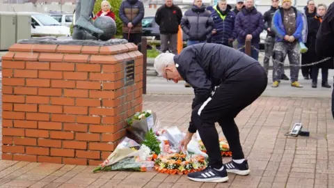 Blackpool FC Head coach Mick McCarthy lays flowers