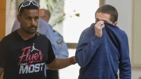 AFP/Getty Images Michael Ron David Kadar (pictured right) allegedly made hundreds of hoax bomb threats