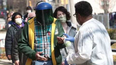 Getty Images Hand sanitiser before voting in Wisconsin