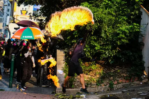 Getty Images A protester throws a petrol bomb in Hong Kong