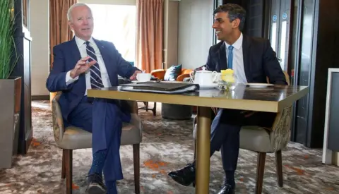 Reuters Joe Biden and Rishi Sunak meet in Belfast in April