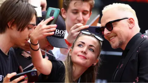 Reuters Cast member Simon Pegg poses for a selfie with a fan as he attends the U.K. Premiere of 'Mission: Impossible - Dead Reckoning Part One' at the Odeon Luxe, London, Britain, June 22, 2023.