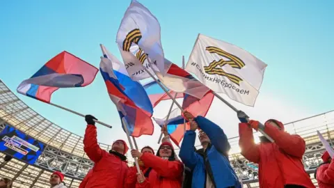RAMIL SITDIKOV/POOL/AFP Among the flags in the Luzhniki stadium were signs bearing the letter Z, a symbol of Russia's war