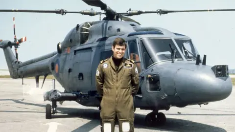 Getty Images Prince Andrew, the Duke of York, in front of a Westland Navy Lynx helicopter in 1983