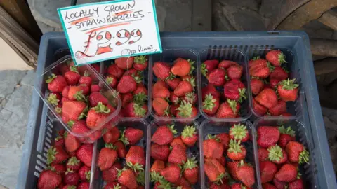 Getty Images Strawberries being sold at a market