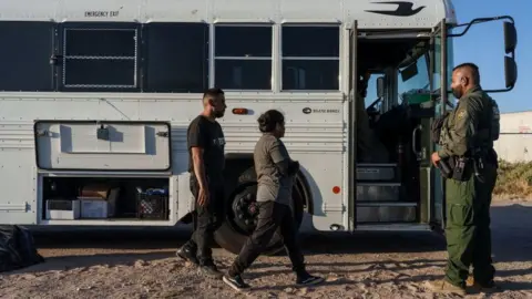 Getty Images Migrants being taken into custody