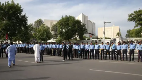 Getty Images Police officers take security measures around Supreme Court of Pakistan in Islamabad, Pakistan on May 11, 2023. Pakistan's top court declares Imran Khan's arrest illegal,