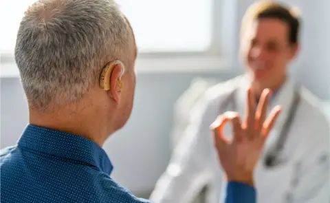 Getty Images Man having hearing tested by doctor