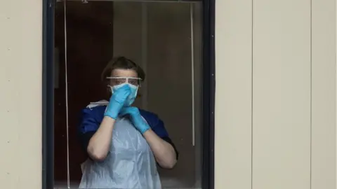 Getty Images Nurse in window