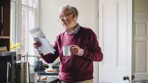 Getty Images old man reading letter