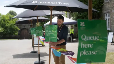 Stefan Rousseau/PA Media Signage at the National Trust's Petworth House, West Sussex, as it welcomes back visitors following the coronavirus lockdown