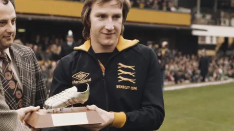Getty Images Wolves player Steve Daley receives his Player of the Year award for the 1976-77 season