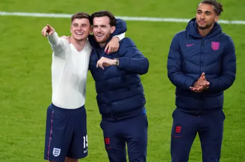 PA Media Mason Mount (left) with Liam Chilwell and Dominic Calvert-Lewin after giving his shirt to Belle