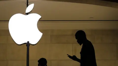 Getty Images A man checks his phone in an Apple retail store in Grand Central Terminal, January 29, 2019 in New York City. Apple is set to report first-quarter earnings results after U.S. markets close on Tuesday.