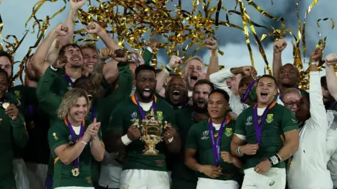 Getty Images South Africa's Springboks celebrate after being handed the World Cup trophy