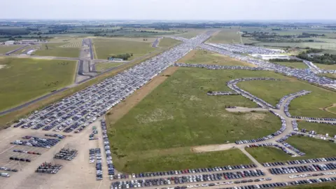 Chris Gorman / Big Ladder.co.uk Aerial view of cars being stored on airport runways