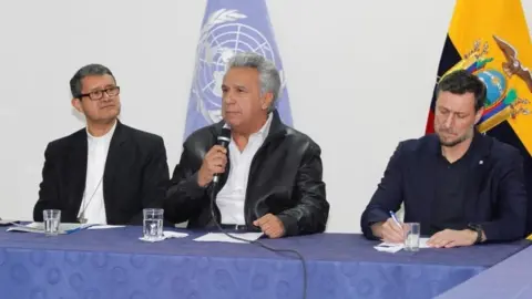 Reuters President Lenin Moreno (C) addresses the audience next to Catholic Bishop Luis Cabrera (L) and Arnaud Peral, representative of the United Nations in Ecuador, in a meeting with the leaders of indigenous communities.