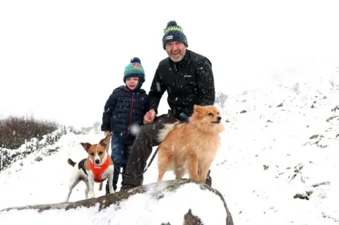 Pacemaker A father, his son and their two dogs walking in the snow on Slemish Mountain