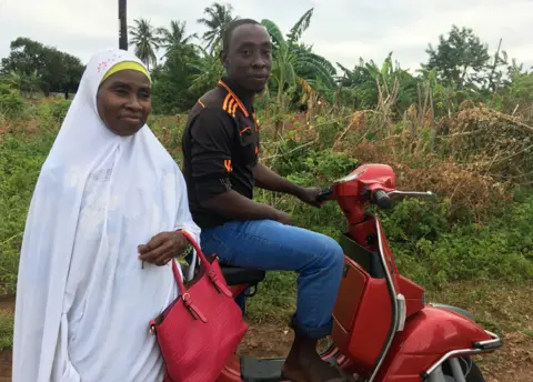 BBC Safia and her son on the scooter she bought