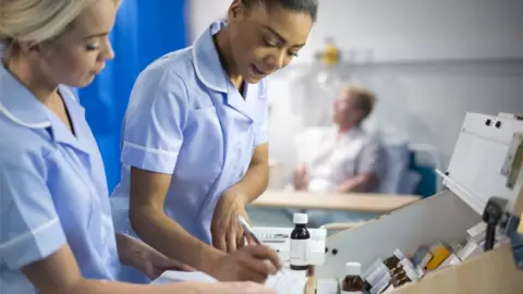 Getty Images Dispensing medicine in a hospital ward