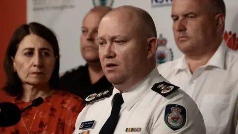 NSW GOVERNMENT Commissioner Shane Fitzsimmons speaking to media with NSW Premier Gladys Berejiklian on his left