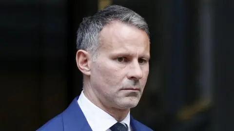 PA Media Ryan Giggs - leaving court on Wednesday - could now face a retrial