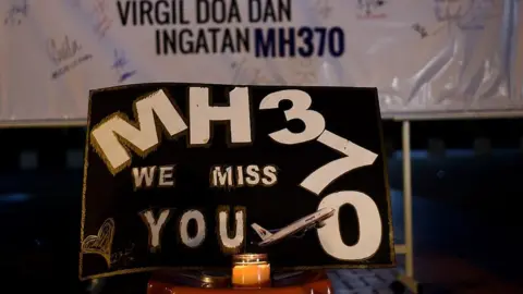 AFP/Getty A message says: "MH370 we miss you"