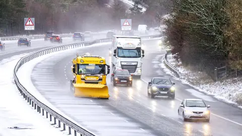 Traffic on the M74 near Abington in South Lanarkshire with snow on the road on December 26, 2022.