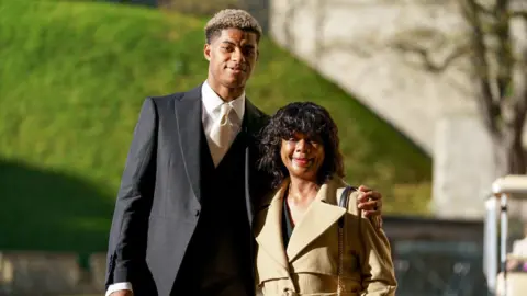 Andrew Matthews / PA WIRE Marcus Rashford with his mother Melanie Rashford