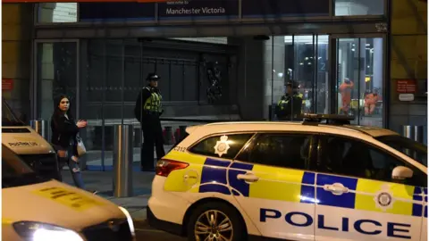 Getty Images Police at Manchester Victoria after stabbing incident on 31 December 2018